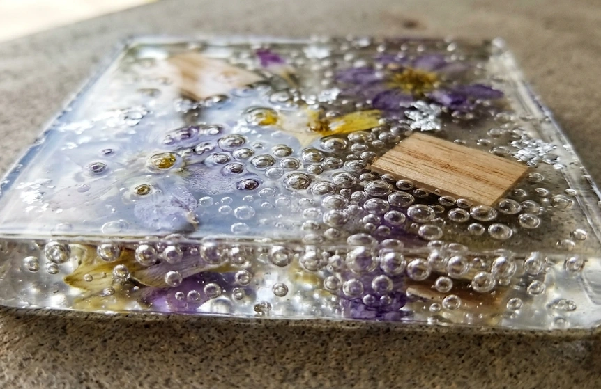 Close up showing frustrating epoxy resin bubbles trapped inside a clear casting project